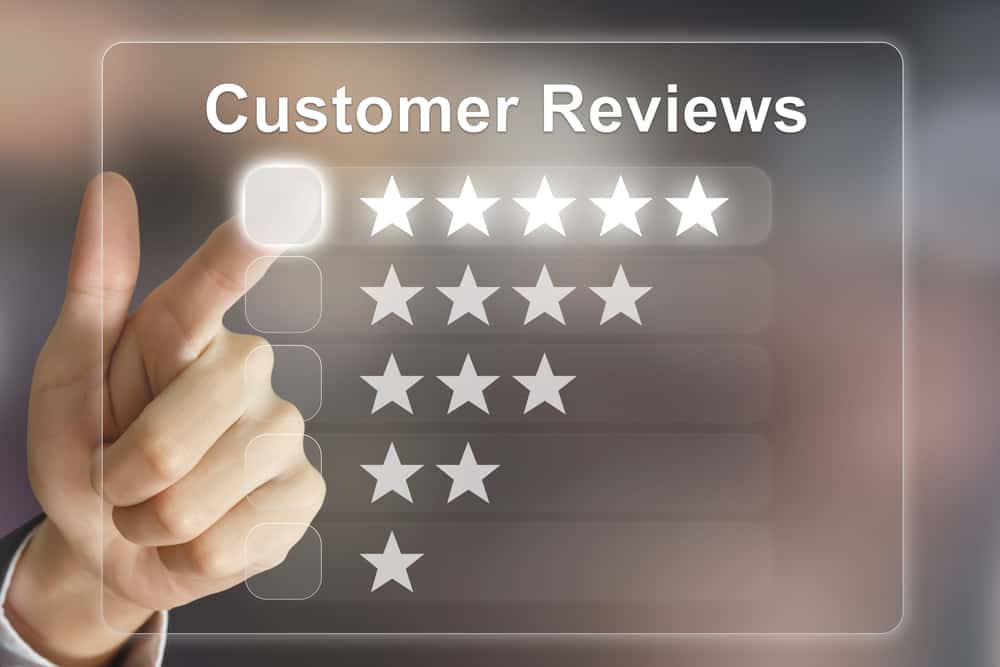 Business hand clicking on customer reviews on virtural screen interface